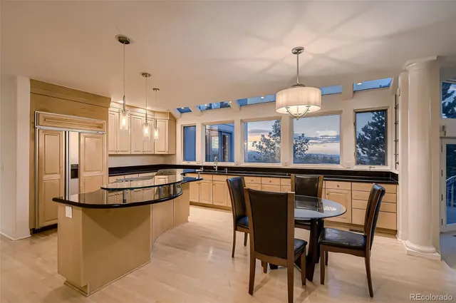 a dining room filled chandelier and wooden floor