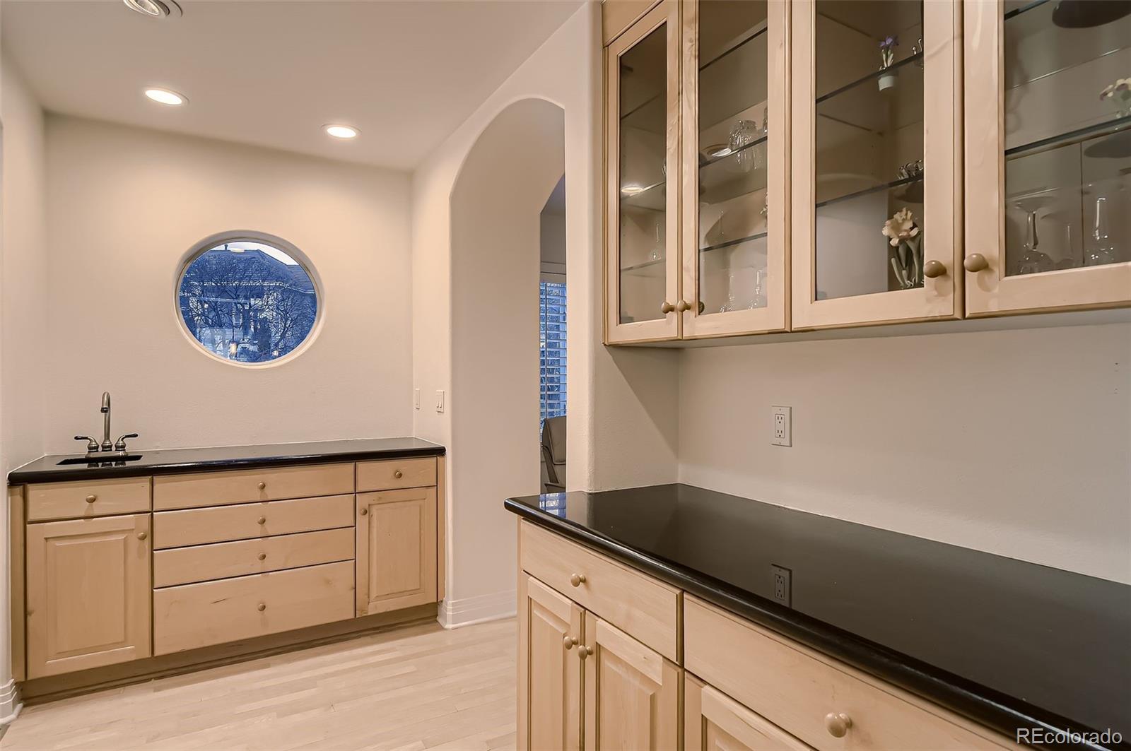 8561 Colonial Drive Lone Tree, CO 80124 - Photo 14 of 50 a kitchen with a sink and cabinets