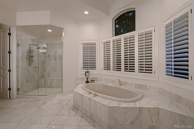 a bathroom with a tub sink and shower