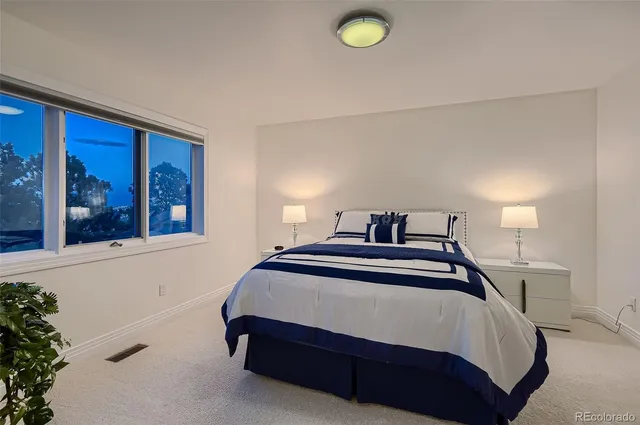 a bedroom with a bed and window