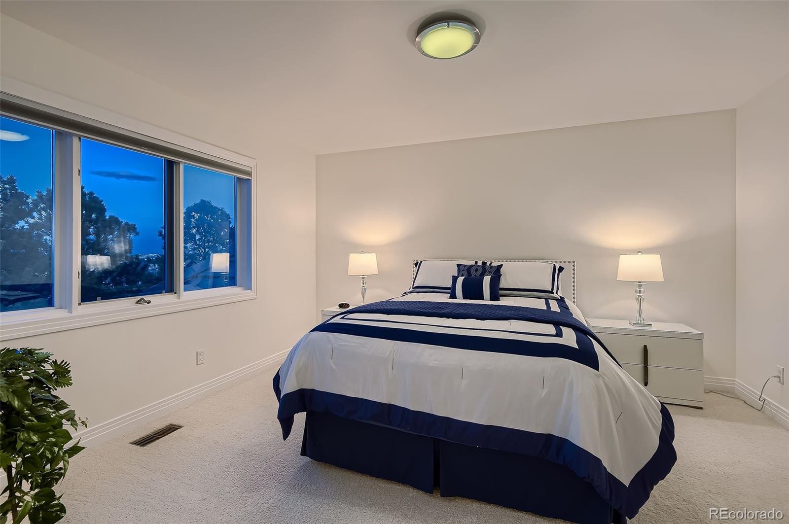8561 Colonial Drive Lone Tree, CO 80124 - Photo 22 of 50 a bedroom with a bed and window