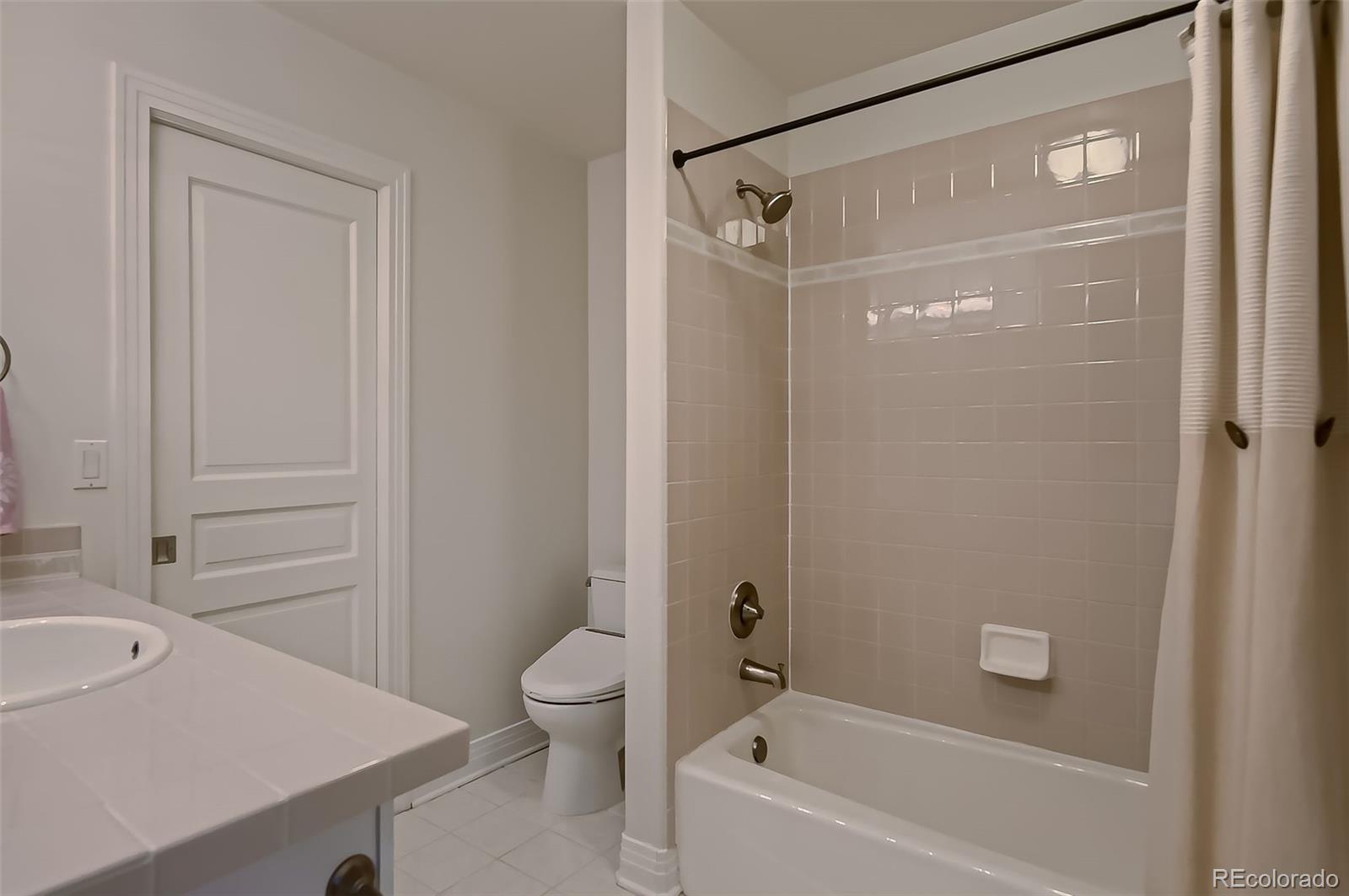 8561 Colonial Drive Lone Tree, CO 80124 - Photo 26 of 50 a bathroom with a shower a bath tub and a sink