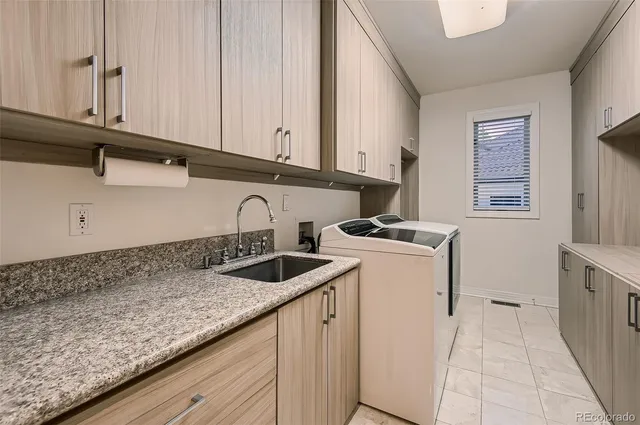 a kitchen with granite countertop a sink and a stove