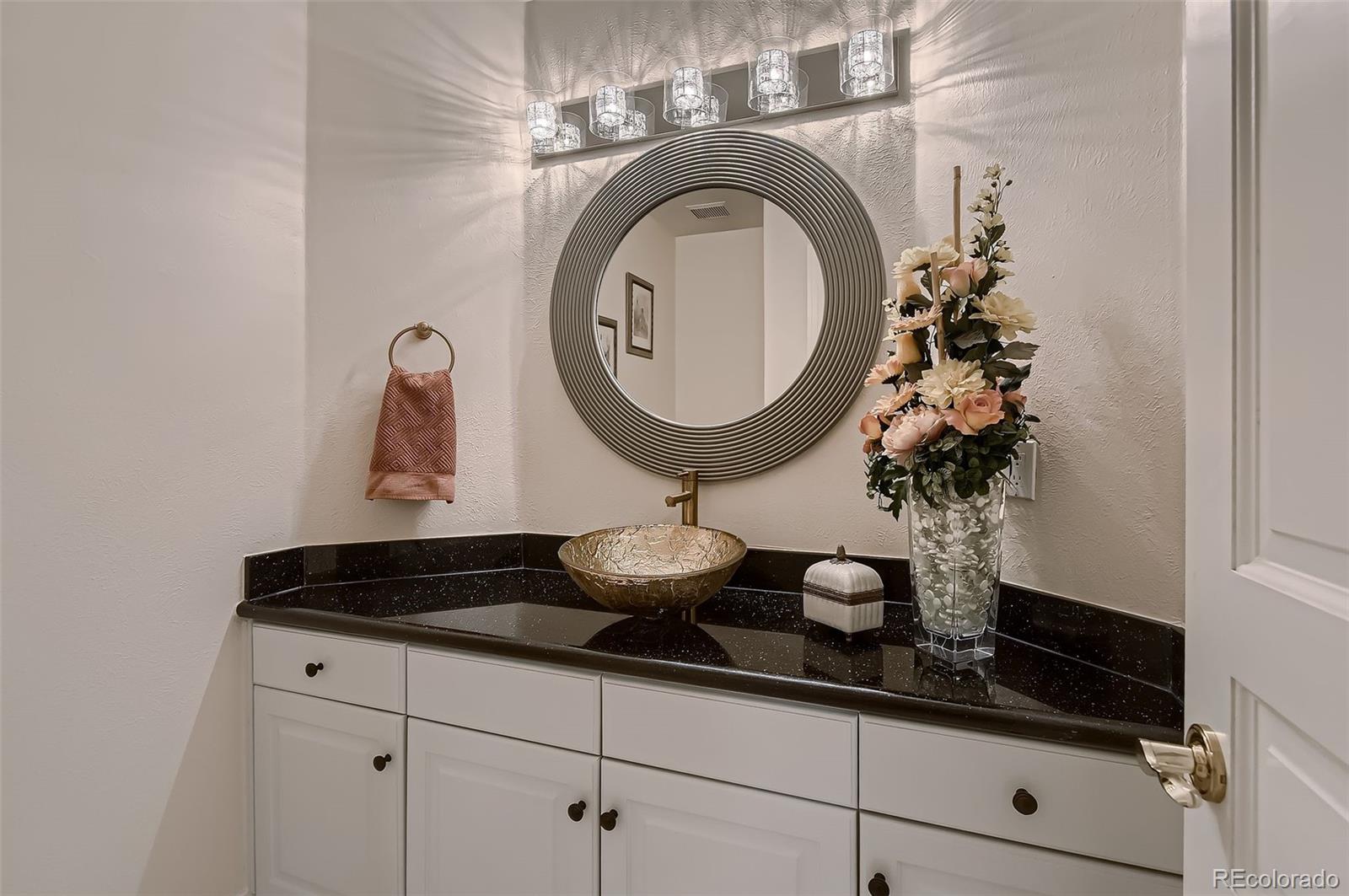 8561 Colonial Drive Lone Tree, CO 80124 - Photo 29 of 50 a close view of light fixtures and a sink