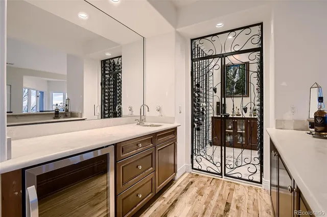 a spacious bathroom with a granite countertop sink a mirror and shower