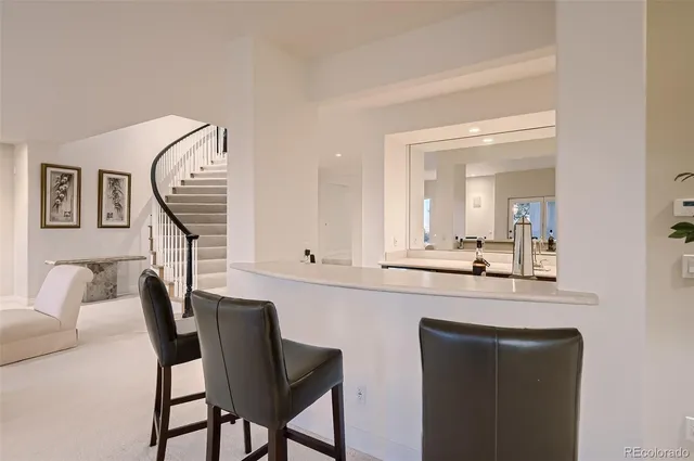 a kitchen with cabinets and chairs