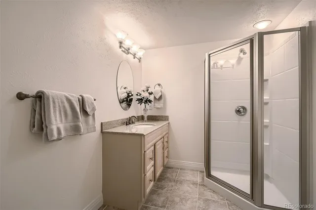 a bathroom with a sink a mirror and shower