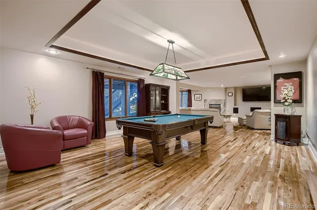 a living room with furniture a flat screen tv and a floor to ceiling window