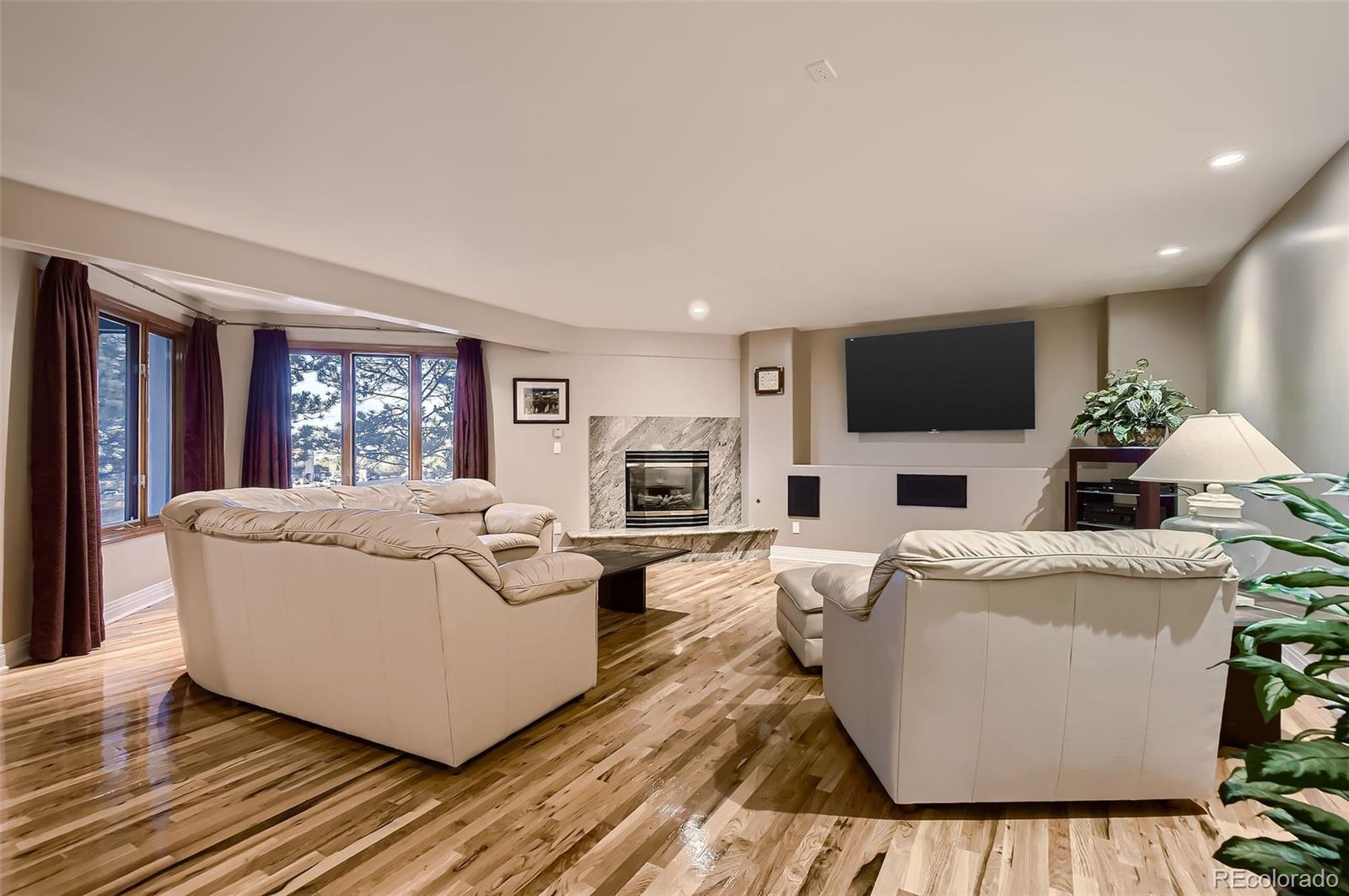 8561 Colonial Drive Lone Tree, CO 80124 - Photo 42 of 50 a living room with furniture and a flat screen tv