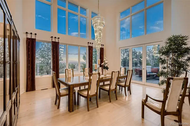 a dining room with furniture and large windows