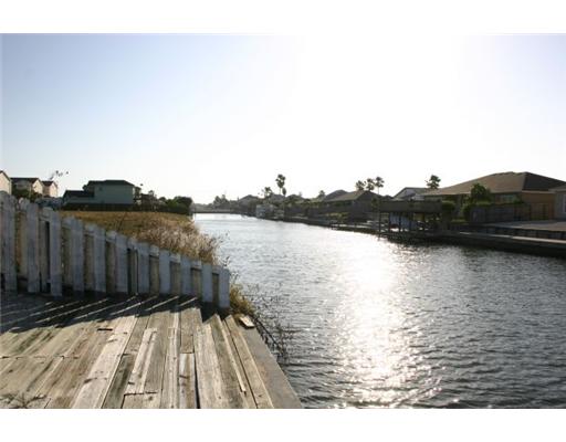 15641 Cruiser Street, Unit B Corpus Christi, TX 78418 - Photo 2 of 2 a view of deck and lake with wooden fence