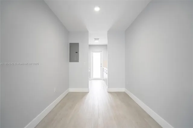 a view of a room with wooden floor and window