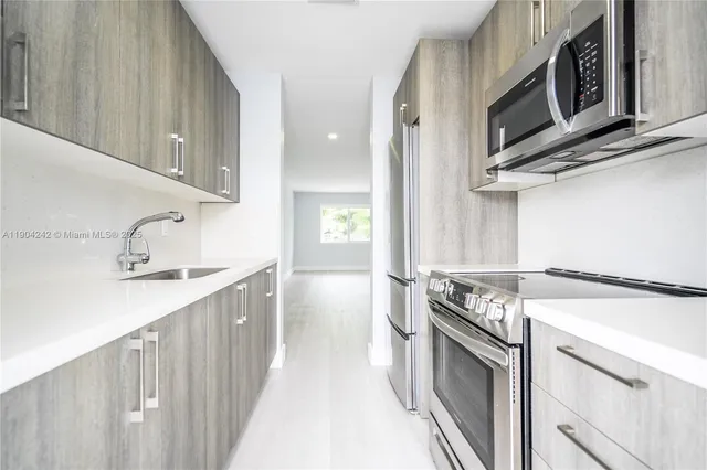 a kitchen with a stove microwave and sink