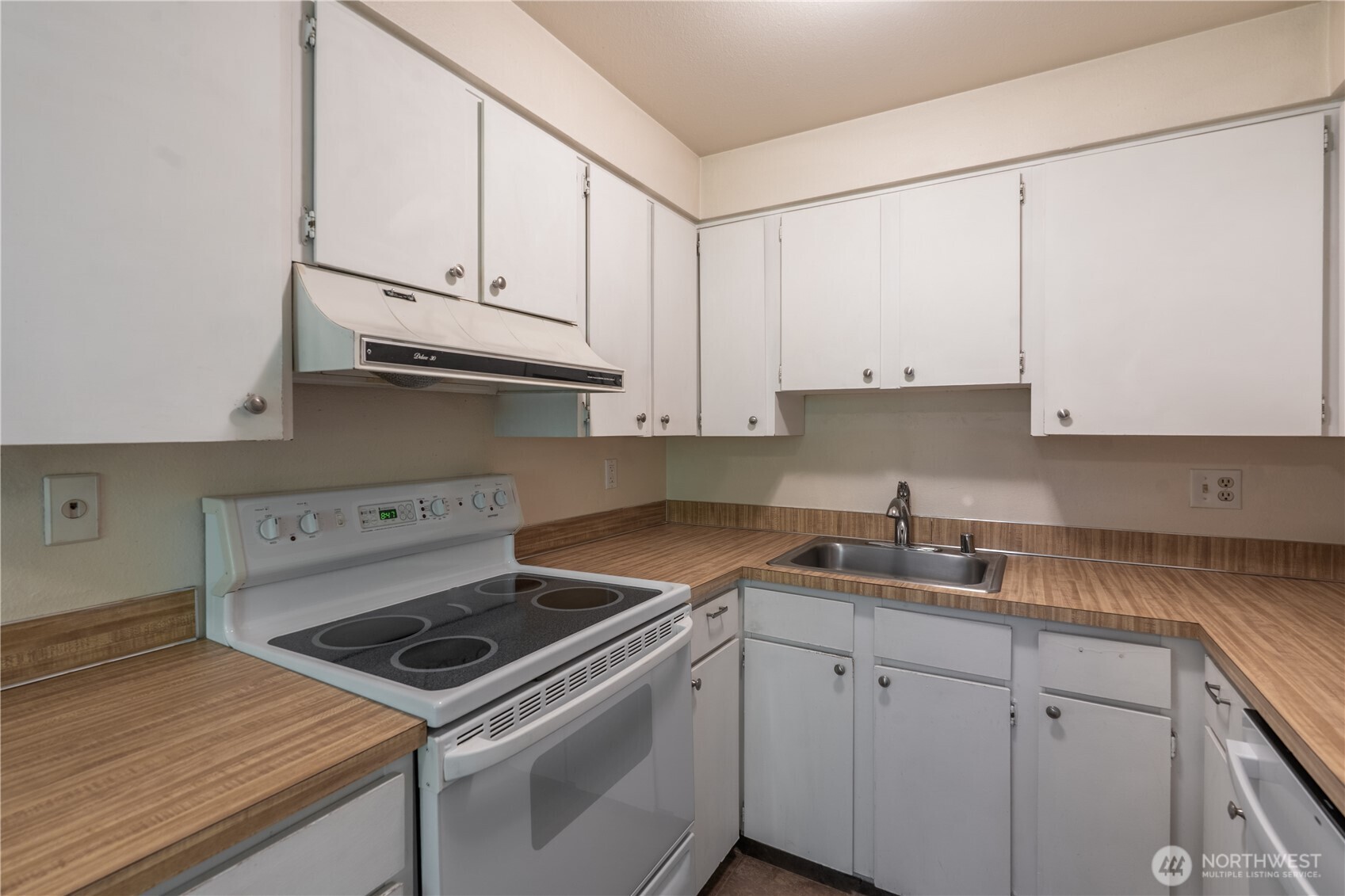 230 Southwest Clark Street, Unit C203 Issaquah, WA 98027 - Photo 6 of 22 a kitchen with granite countertop white cabinets and white appliances