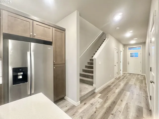 a view of a hallway with closet and windows