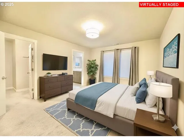 a view of an empty room with window and bathroom