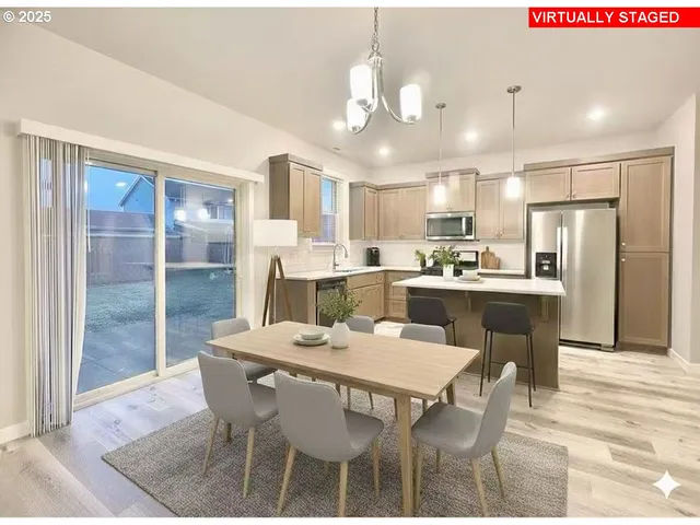 a dining area with a table chairs and refrigerator