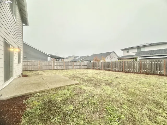 a view of a house with backyard and porch
