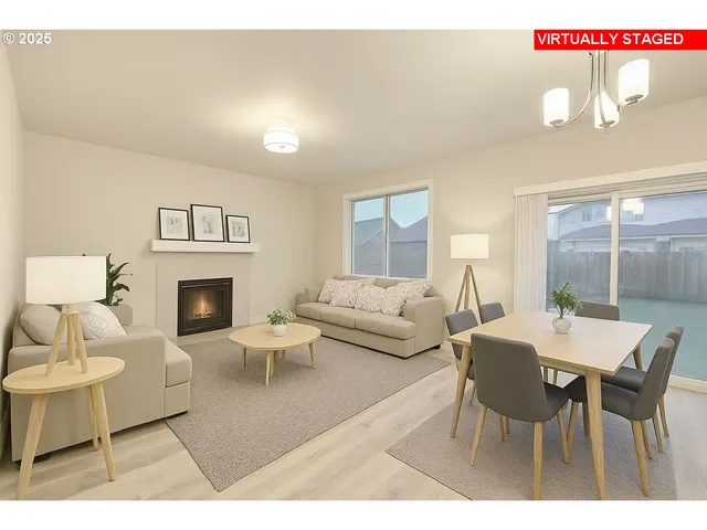 a living room with furniture a fireplace and a table