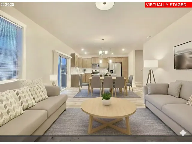 a living room with furniture kitchen and a table