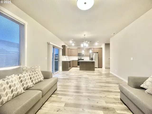 a living room with furniture and kitchen view