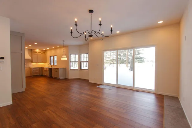 a view of a room with wooden floor and windows