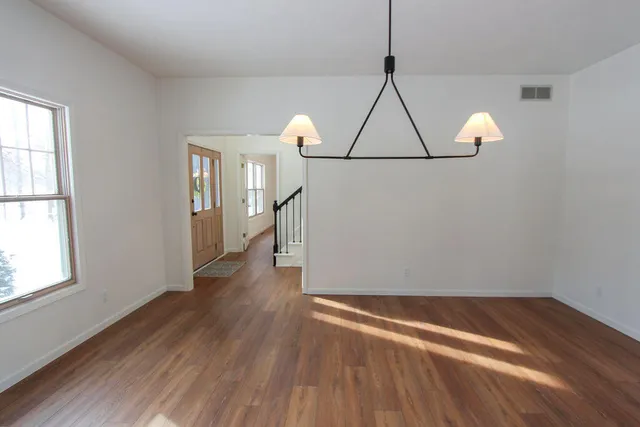 a view of room with window and wooden floor