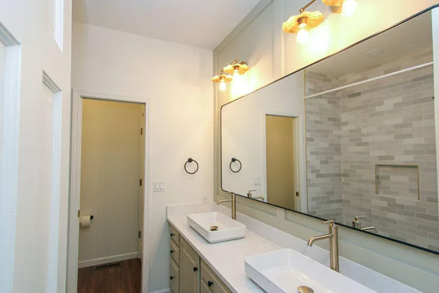 a bathroom with a tub sink and mirror