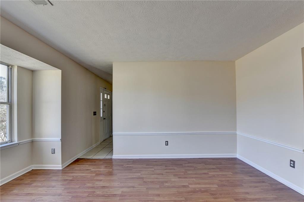 2082 Montgomery Trail Duluth, GA 30096 - Photo 12 of 45 an empty room with wooden floor and windows