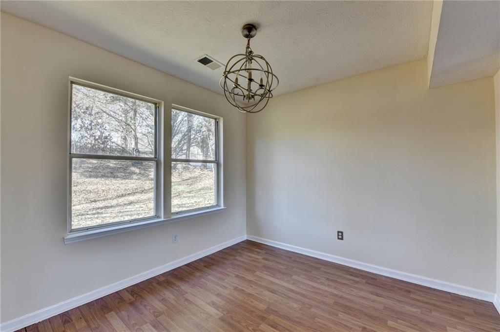 2082 Montgomery Trail Duluth, GA 30096 - Photo 15 of 45 a view of an empty room with window and wooden floor