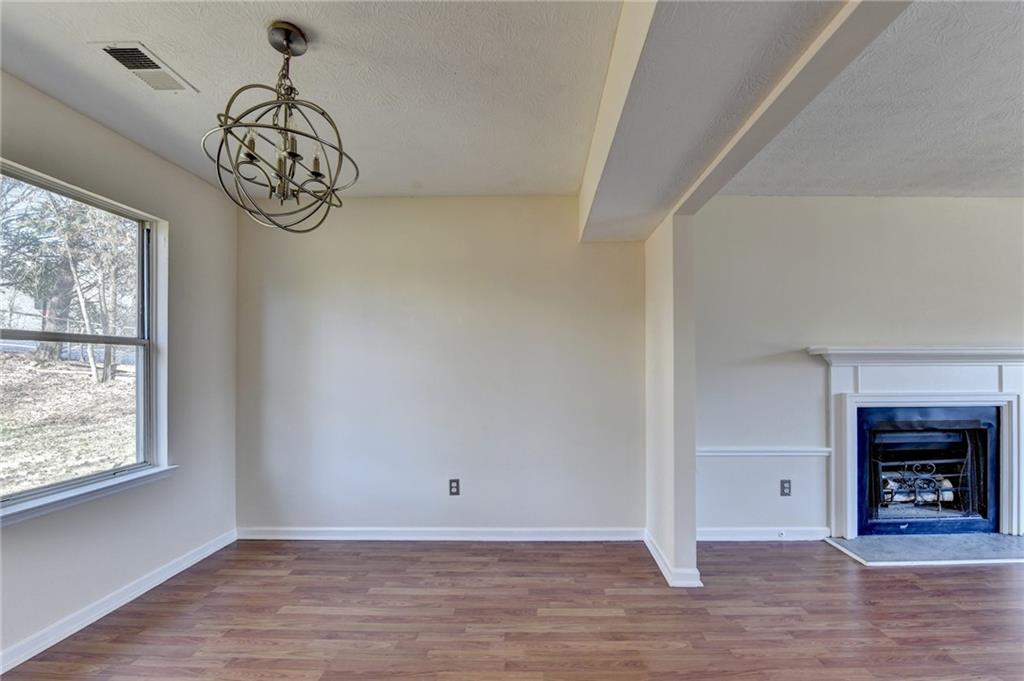 2082 Montgomery Trail Duluth, GA 30096 - Photo 16 of 45 a view of a hallway with wooden floor and a chandelier