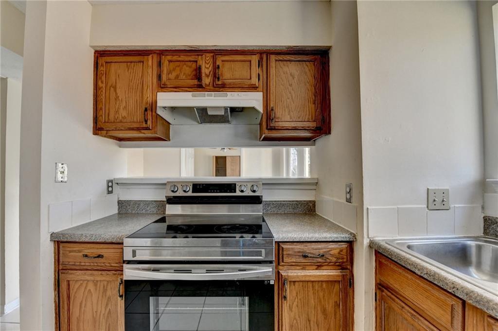 2082 Montgomery Trail Duluth, GA 30096 - Photo 19 of 45 a kitchen with stainless steel appliances granite countertop a stove and a sink