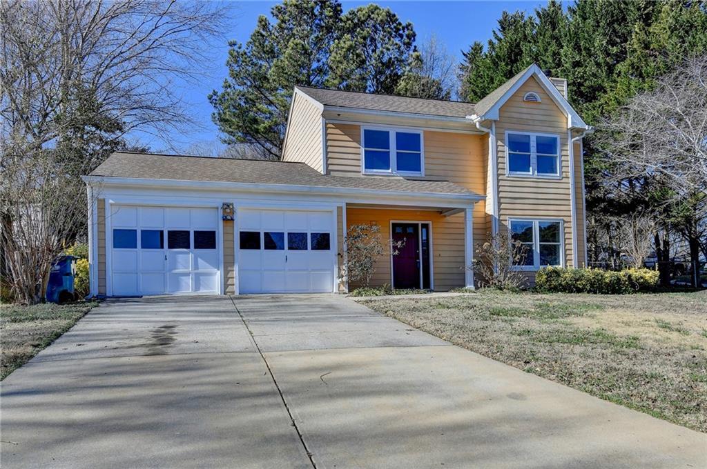 2082 Montgomery Trail Duluth, GA 30096 - Photo 2 of 45 a front view of a house with a garden