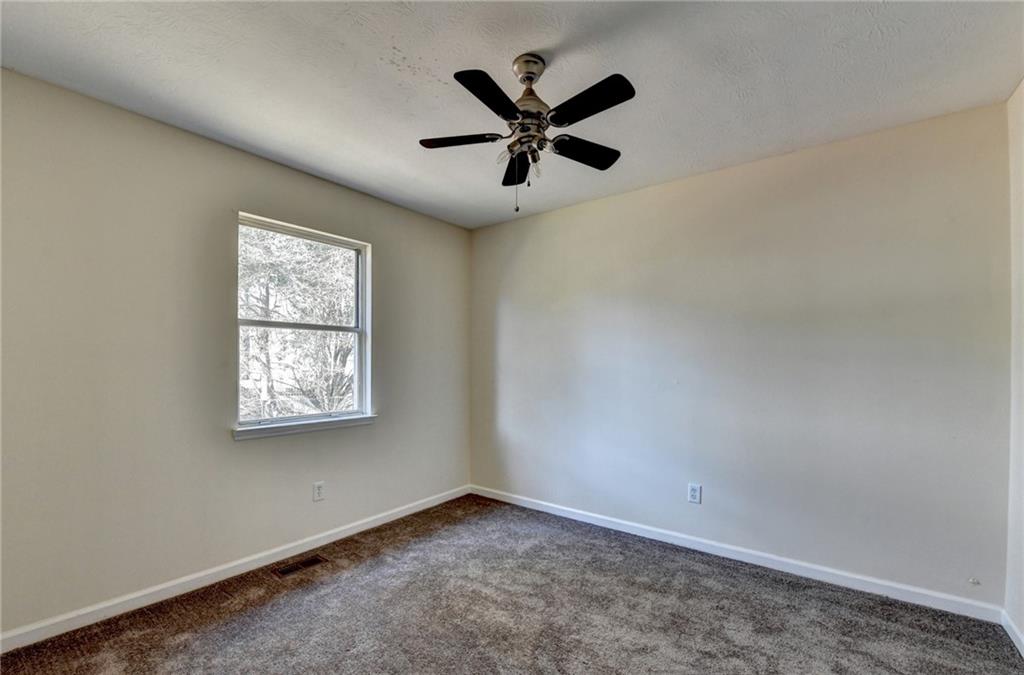 2082 Montgomery Trail Duluth, GA 30096 - Photo 28 of 45 an empty room with ceiling fan and window