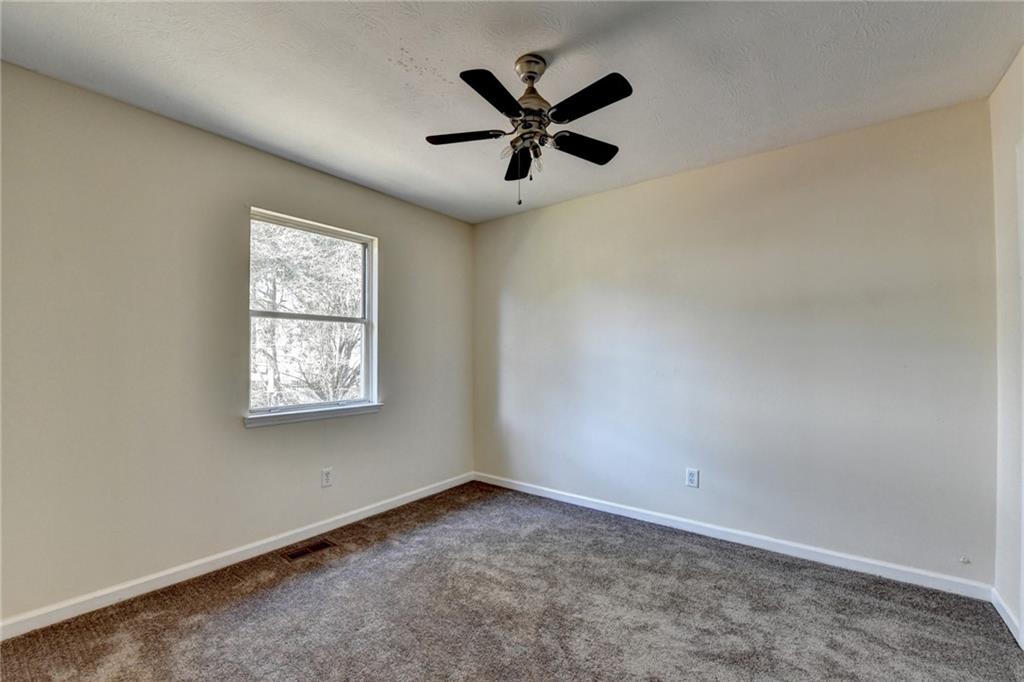 2082 Montgomery Trail Duluth, GA 30096 - Photo 29 of 45 an empty room with window and ceiling fan
