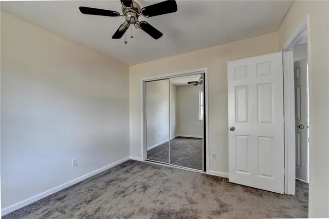 an empty room and chandelier fan