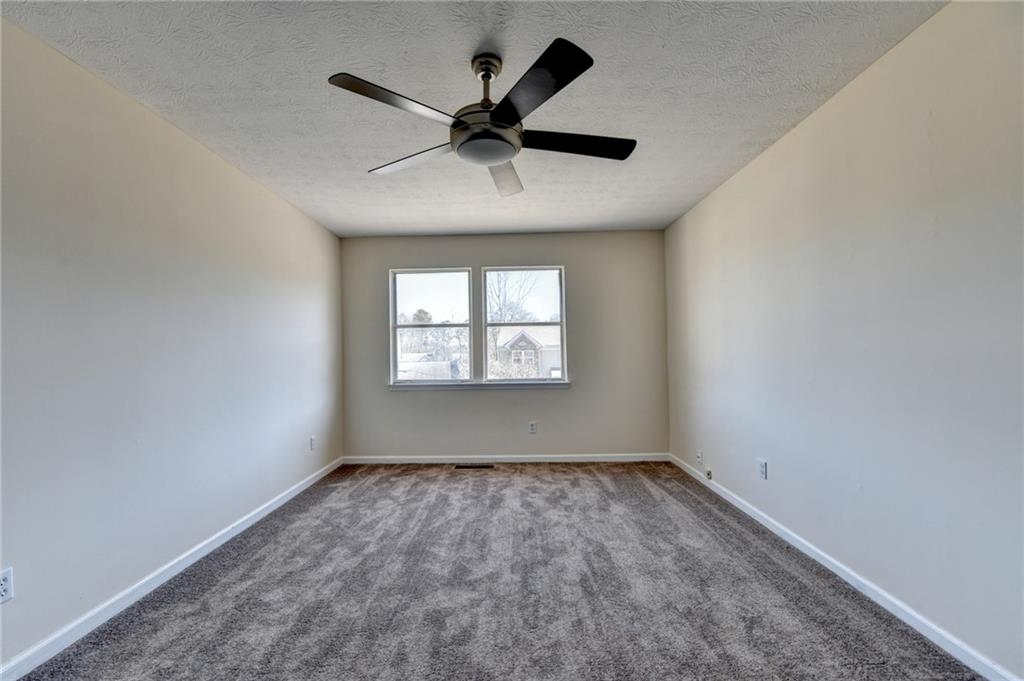2082 Montgomery Trail Duluth, GA 30096 - Photo 34 of 45 an empty room with ceiling fan and window