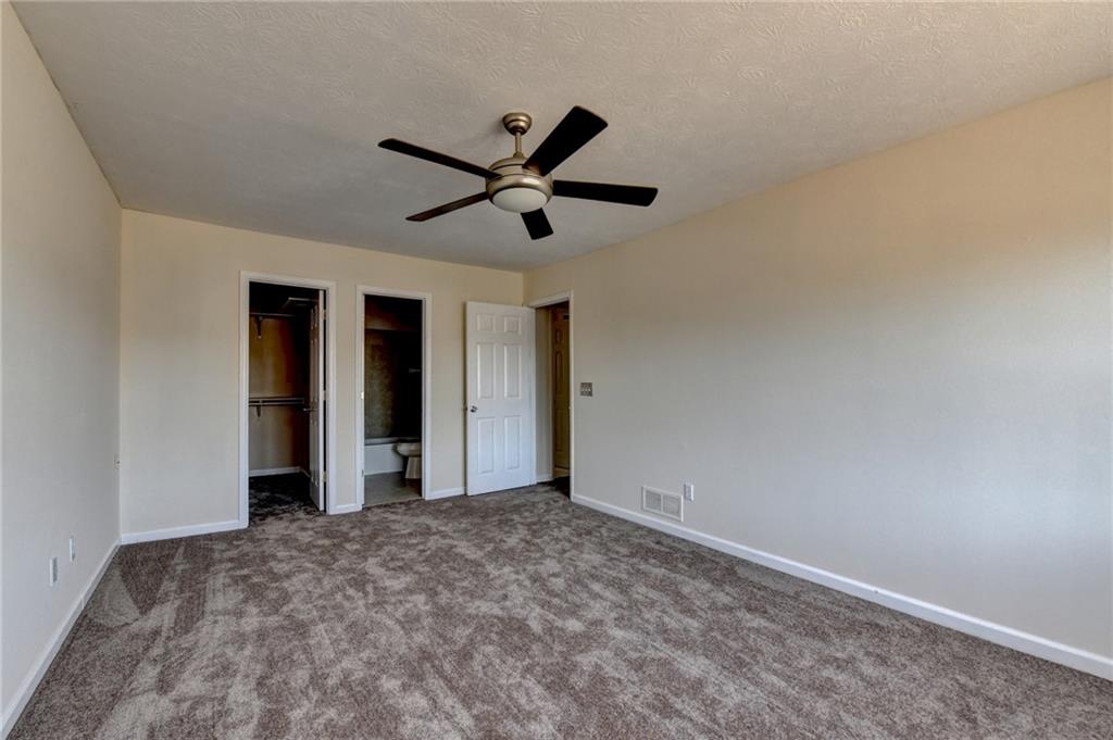 2082 Montgomery Trail Duluth, GA 30096 - Photo 35 of 45 a view of a big room with wooden floor and a ceiling fan