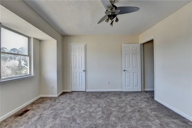 a view of room with a ceiling fan and window