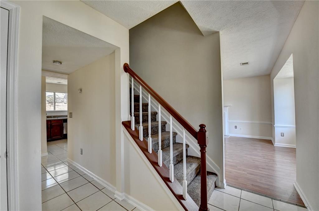 2082 Montgomery Trail Duluth, GA 30096 - Photo 5 of 45 a view of a hallway with wooden floor and staircase