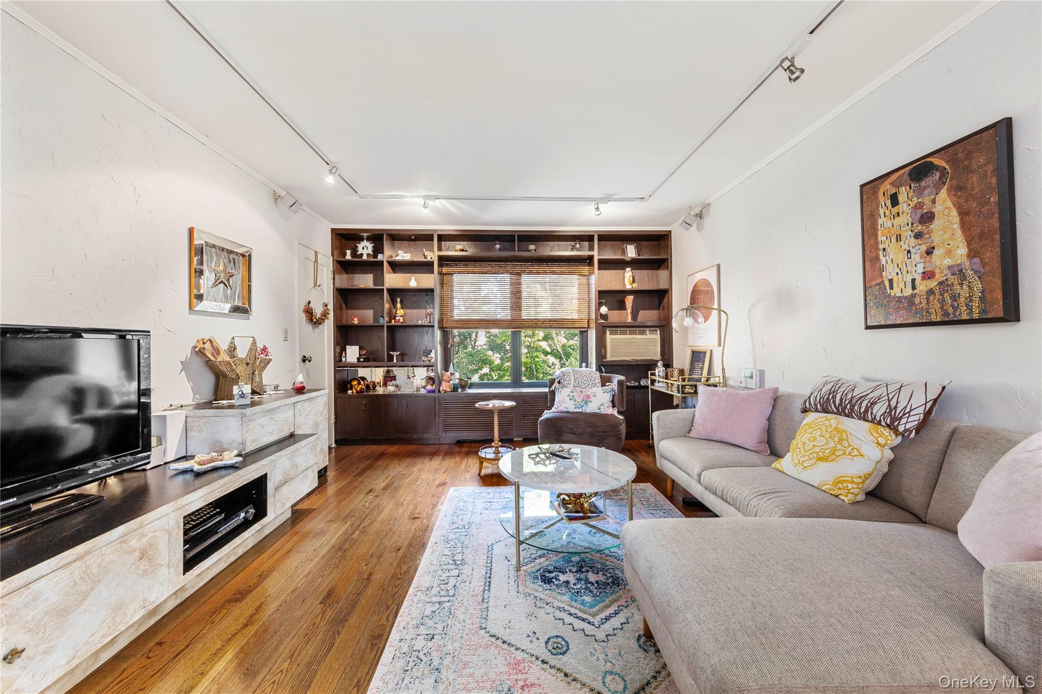 16 Terrace Circle, Unit 14C Great Neck, NY 11021 - Photo 2 of 9 Living area featuring track lighting and wood finished floors