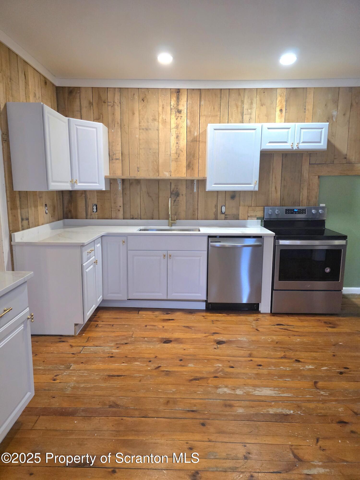 28 Pine Street Tunkhannock, PA 18657 - Photo 11 of 50 a large kitchen with stainless steel appliances granite countertop a stove a sink and a refrigerator