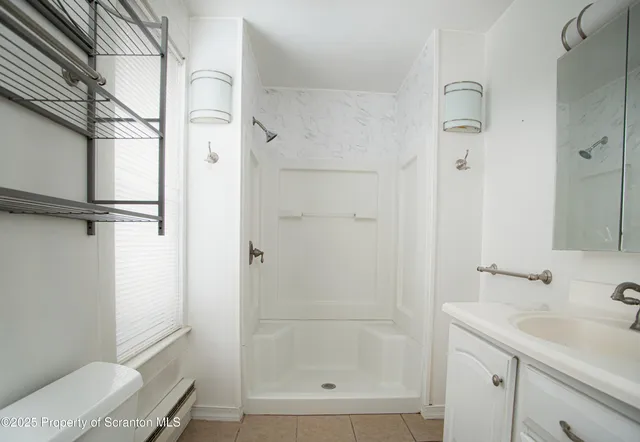 a bathroom with a bathtub and shower