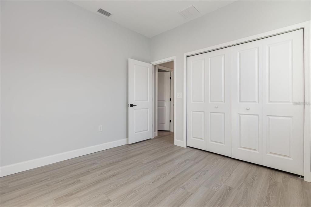 13451 Kaplan Terrace Port Charlotte, FL 33981 - Photo 15 of 27 a view of an empty room with wooden floor