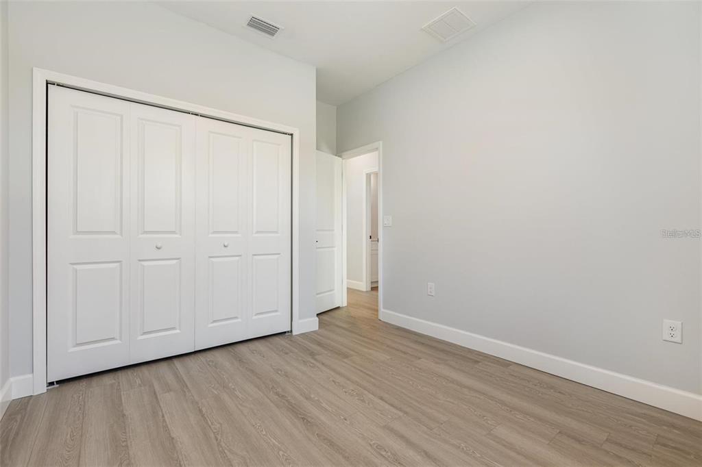 13451 Kaplan Terrace Port Charlotte, FL 33981 - Photo 17 of 27 a view of an empty room with wooden floor