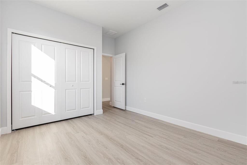 13451 Kaplan Terrace Port Charlotte, FL 33981 - Photo 20 of 27 a view of an empty room with wooden floor