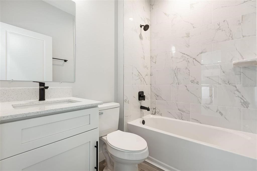 13451 Kaplan Terrace Port Charlotte, FL 33981 - Photo 21 of 27 a bathroom with a sink a toilet and a bathtub