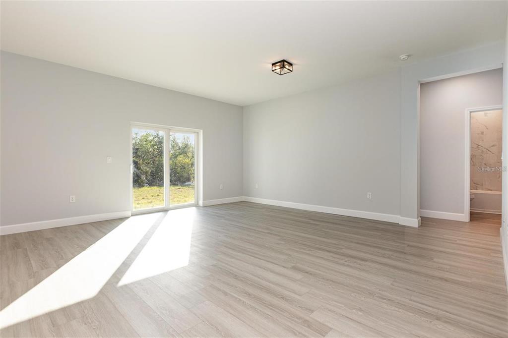 13451 Kaplan Terrace Port Charlotte, FL 33981 - Photo 4 of 27 a view of an empty room with wooden floor and a window