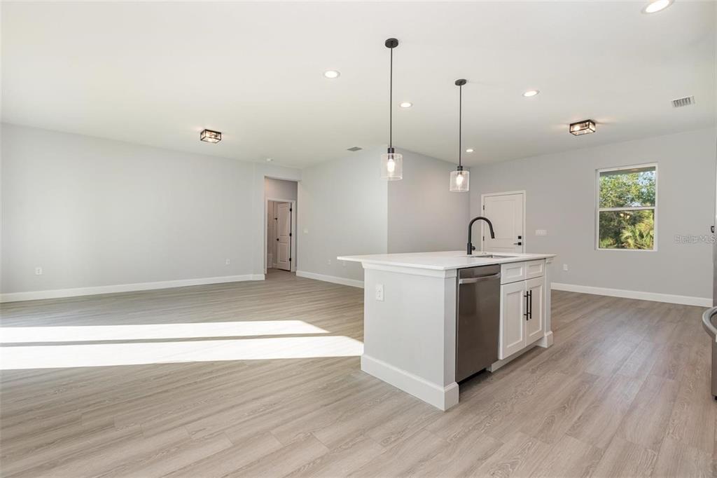 13451 Kaplan Terrace Port Charlotte, FL 33981 - Photo 9 of 27 a view of a kitchen with wooden floor and stainless steel appliances
