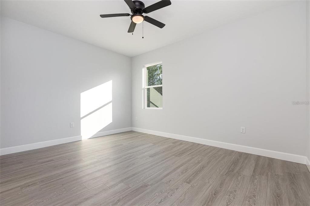 13451 Kaplan Terrace Port Charlotte, FL 33981 - Photo 10 of 27 wooden floor in an empty room with a window